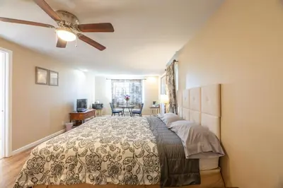 a bedroom with a bed and a ceiling fan at St Annas House in Squaw Valley