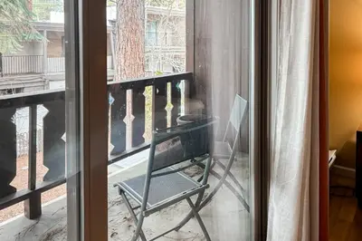 a glass window with a chair on a balcony at Incline Village Creekside Retreat in Incline Village