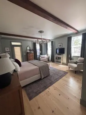 a bedroom with a bed and a living room at The Firehouse Inn-Cottage in Mariposa
