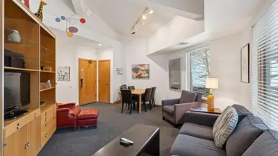 a living room with a couch and a table at The Ridgeline by AvantStay Shared Pool Hot Tub Sauna Ski-In Access Village Walk in Olympic Valley