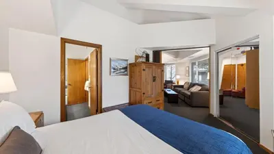 a bedroom with a bed and a living room at The Ridgeline by AvantStay Shared Pool Hot Tub Sauna Ski-In Access Village Walk in Olympic Valley