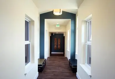 a hallway with a blue door in a building at Rest, a boutique hotel in Plymouth