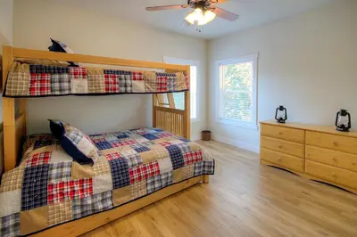 a bedroom with a bunk bed and a dresser at River Rock Retreat in Yosemite West