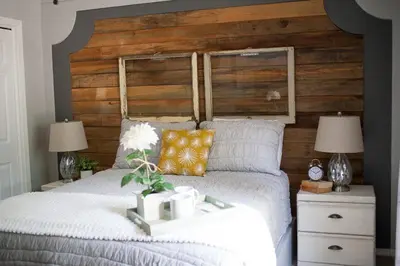 a bedroom with a large bed with a wooden headboard at Lazy Z Resort in Twain Harte