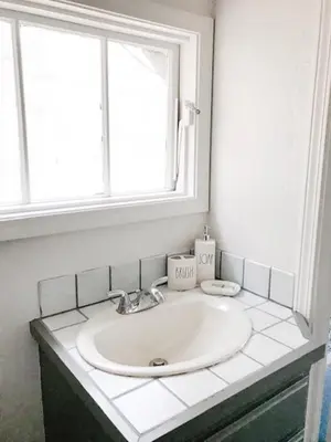 a white sink in a bathroom with a window at Lazy Z Resort in Twain Harte