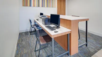a desk with a computer on top of it at Holiday Inn Express & Suites Dinuba West by IHG in Dinuba