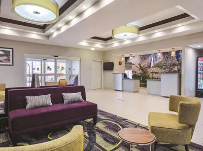 a lobby with a couch and a table and chairs at La Quinta by Wyndham Fresno Northwest in Fresno