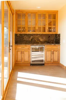 a kitchen with wooden cabinets and a stove at Mountain Shadows Retreat in Foresthill