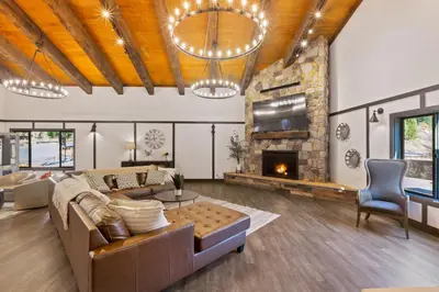 a living room with a couch and a fireplace at Yosemite Lakes Bunkhouses in Harden Flat