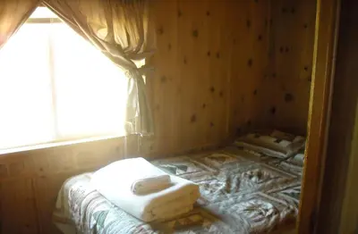 a room with a bed with two towels on it at Yosemite Lakes Cabin 37 in Harden Flat