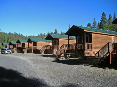 a row of lodges with a car parked in front at Yosemite Lakes Cabin 39 in Harden Flat
