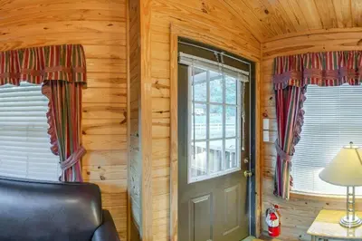 a room with a door and a window in a cabin at Yosemite Lakes Cabin & Cottages in Harden Flat