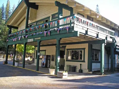 a building with a balcony with flags on it at Yosemite Lakes Cottage 47 in Harden Flat