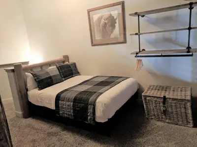 a bedroom with a bed and a picture on the wall at Village Treehouse #2 in Mammoth Lakes