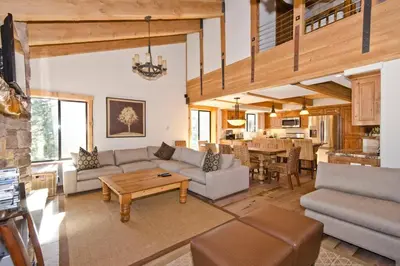 a living room with a couch and a table at Village Treehouse #2 in Mammoth Lakes