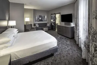 a hotel room with a large bed and a television at DoubleTree by Hilton Modesto in Modesto