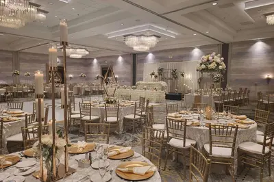 a banquet hall with tables and chairs and chandeliers at DoubleTree by Hilton Modesto in Modesto