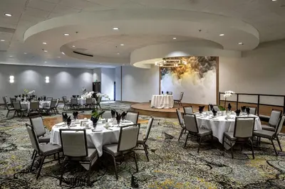a banquet hall with tables and chairs in a room at DoubleTree by Hilton Modesto in Modesto