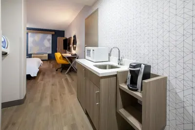 a kitchen with a sink and a microwave at Holiday Inn Express & Suites Lathrop by IHG in Lathrop