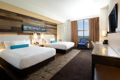 a hotel room with two beds and a television at Chukchansi Gold Resort & Casino in Coarsegold