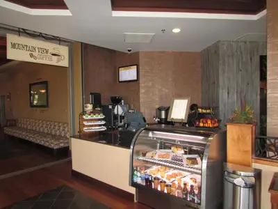 a restaurant with a counter with a refrigerator at Chukchansi Gold Resort & Casino in Coarsegold