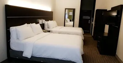a hotel room with two beds with white pillows at Holiday Inn Express Madera by IHG in Madera