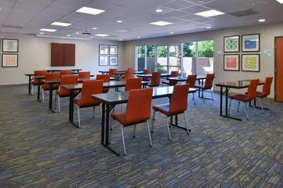 a conference room with tables and chairs in it at Holiday Inn Express Madera by IHG in Madera