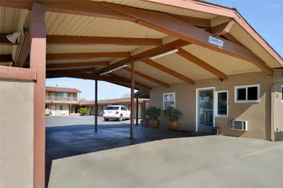 a covered parking lot in front of a building at Americas Best Value Inn Los Banos in Los Banos