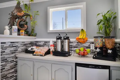 a kitchen counter with fruits and vegetables on it at Americas Best Value Inn Los Banos in Los Banos