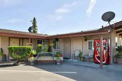 a house with a coke machine on the side of it at Americas Best Value Inn Los Banos in Los Banos