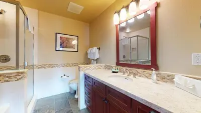 a bathroom with a sink and a toilet and a mirror at Juniper Crest 1 Apartment in Mammoth Lakes
