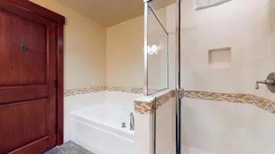 a bathroom with a shower and a tub and a bath tub at Juniper Crest 1 Apartment in Mammoth Lakes