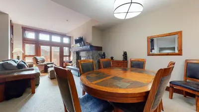 a dining room with a table and a fireplace at Juniper Crest 6 Apartment in Mammoth Lakes