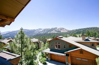 a home in the mountains with snow on the roofs at Juniper Crest 6 Apartment in Mammoth Lakes