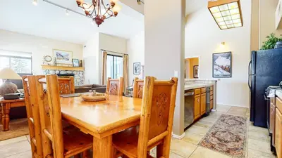 a kitchen and dining room with a wooden table and chairs at Mammoth Reservations in Mammoth Lakes