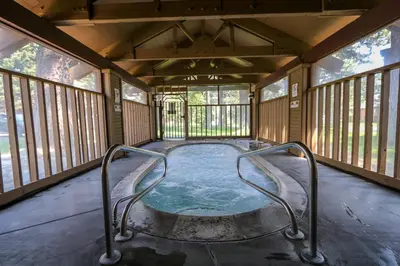 a hot tub in a screened in porch with windows at Mammoth Reservations in Mammoth Lakes