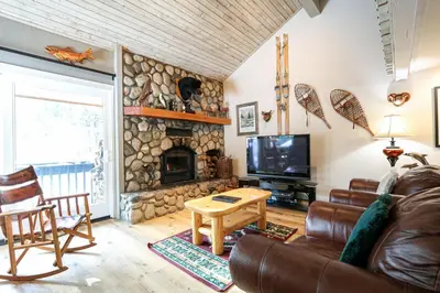 a living room with a couch and a fireplace at Mammoth Reservations in Mammoth Lakes