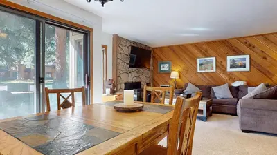 a living room with a table and a couch at Mammoth Reservations in Mammoth Lakes