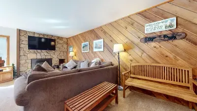 a living room with a couch and a fireplace at Mammoth Reservations in Mammoth Lakes