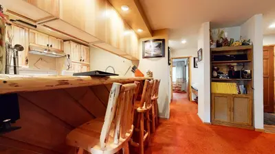 a kitchen with a counter and some wooden cabinets at Snowcreek 253 Apartment in Mammoth Lakes