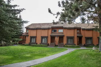 a large house with a lawn in front of it at Snowcreek 253 Apartment in Mammoth Lakes