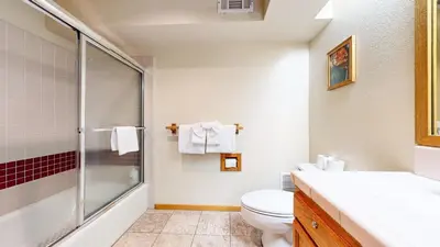 a bathroom with a shower and a toilet and a sink at Snowcreek 638 Apartment in Old Mammoth
