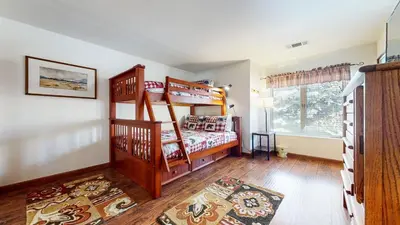 a bedroom with two bunk beds and a rug at Snowcreek 638 Apartment in Old Mammoth