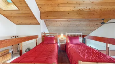 two beds in a room with wooden ceilings at Snowcreek 638 Apartment in Old Mammoth