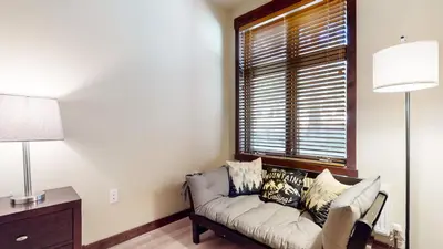 a living room with a couch and a window at Solstice 10 Apartment in Mammoth Lakes