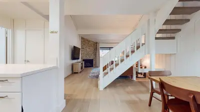 a kitchen and dining room with a staircase in a house at Mammoth Reservations in Mammoth Lakes