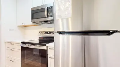 a stainless steel refrigerator in a kitchen with a microwave at Mammoth Reservations in Mammoth Lakes