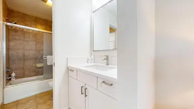 a white bathroom with a sink and a mirror at Mammoth Reservations in Mammoth Lakes