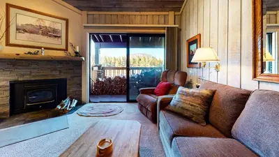 a living room with a couch and a fireplace at Summit 34 Apartment in Mammoth Lakes