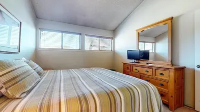 a bedroom with a bed and a dresser with a mirror at Summit 34 Apartment in Mammoth Lakes